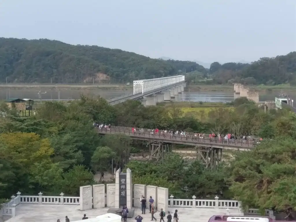 People crossing the Bridge of Freedom at Imjingak. In the background you can see the railway bridge that connects with Freedom Bridge.