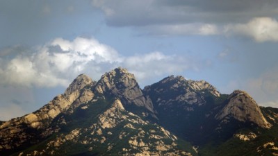 A mountain in Bukhansan National Park looking dark green from all the leaves