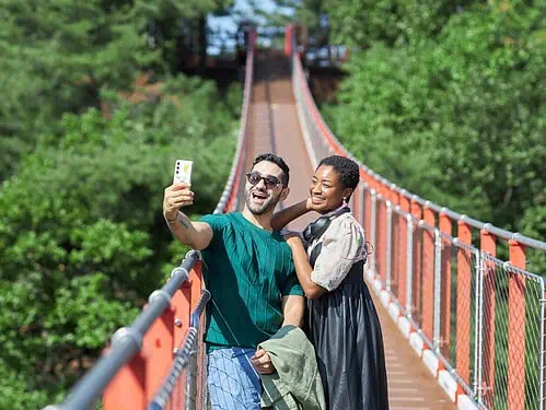 A couple taking a selfie on the Gamaksan Red Suspension Bridge during our Best DMZ Tour from Seoul