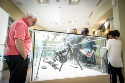 A man looking at a gun display inside the DMZ Exhibition Hall.