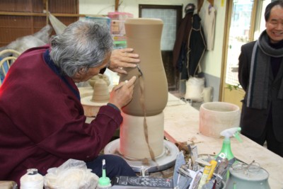 A Korean pottery master hard at work moulding a clay vase