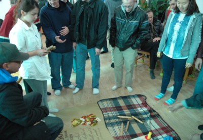 People playing a traditional Korean folk game called Yut Nori