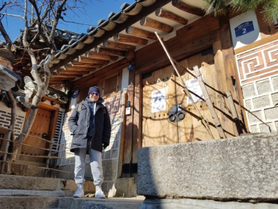 Posing for a photo outside a beautiful traditional style hanok house