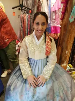 A young lady wearing a blue and beige Korean Hanbok