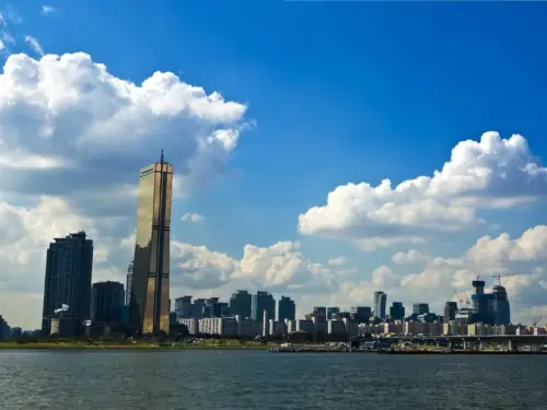 Looking at the gold colored 63 Building located on Yeouido Hangang Park from across the Han River