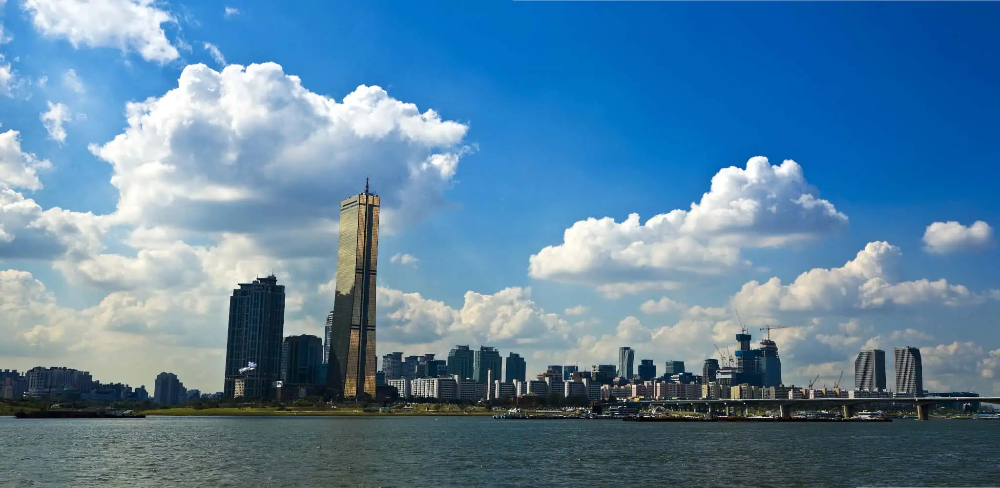 Looking at the gold colored 63 Building located on Yeouido Hangang Park from across the Han River