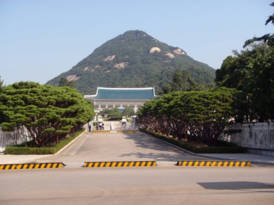 Looking at the Blue House with its pretty garden and scenic mountain backdrop.