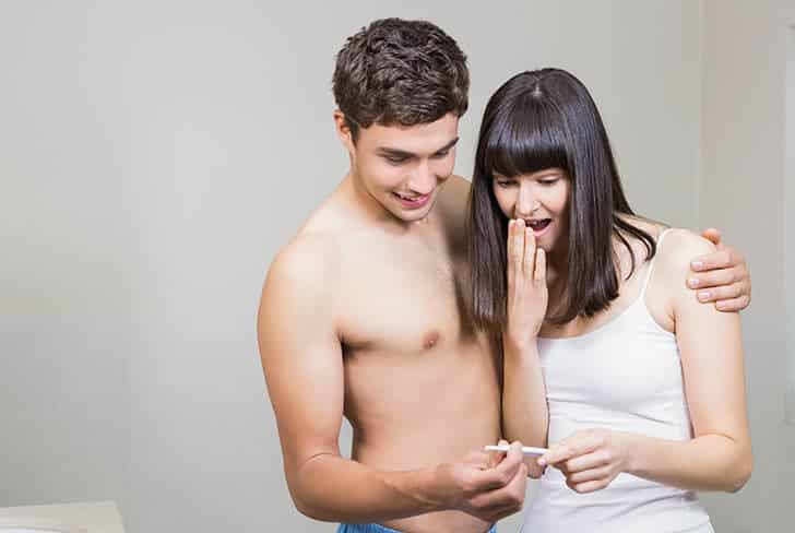 Couple looking at a pregnancy test after infertility treatment