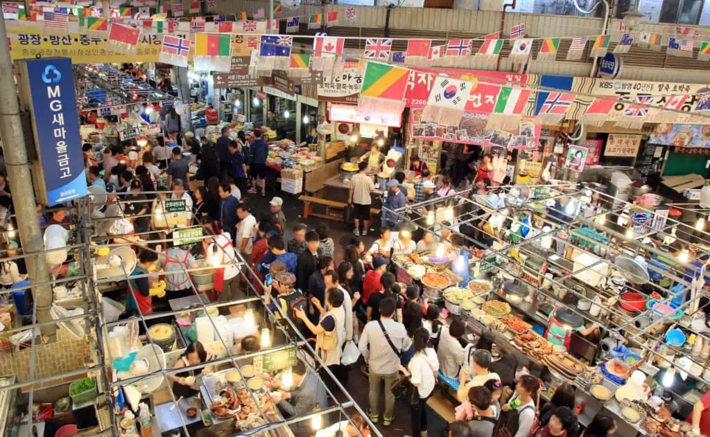 People queuing up for food at the busy Gwangjang Market in Seoul