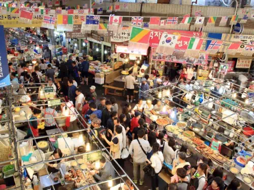 People queuing up for food at the busy Gwangjang Market in Seoul