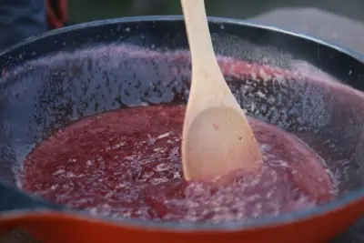 Making strawberry jam in a frying pan