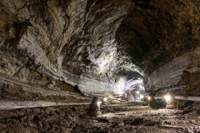 Looking down the brightly lit tunnel inside Manjanggul Cave