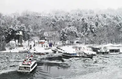 The Nami Island ferry docking at Nami Island Wharf in Winter with icy water and snow covered trees