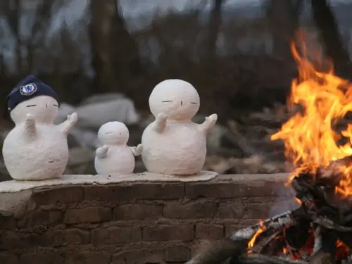 Snowmen enjoying the warm fire at Nami Island in Winter