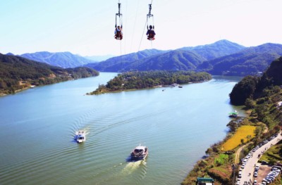 Two people taking the zipline to Nami Island