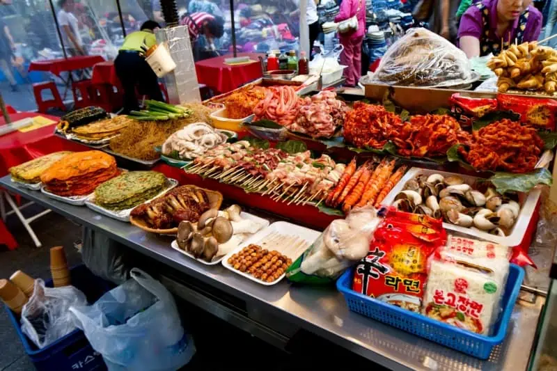 A night market in Seoul selling food from a stall including Korean style pancake (Jeon)