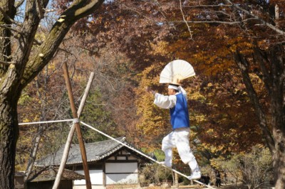 A traditional tight rope performer putting on a hilarious performance at the Korean folk village