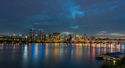 A tranquil night view of the Han River with bright lights glowing off the water