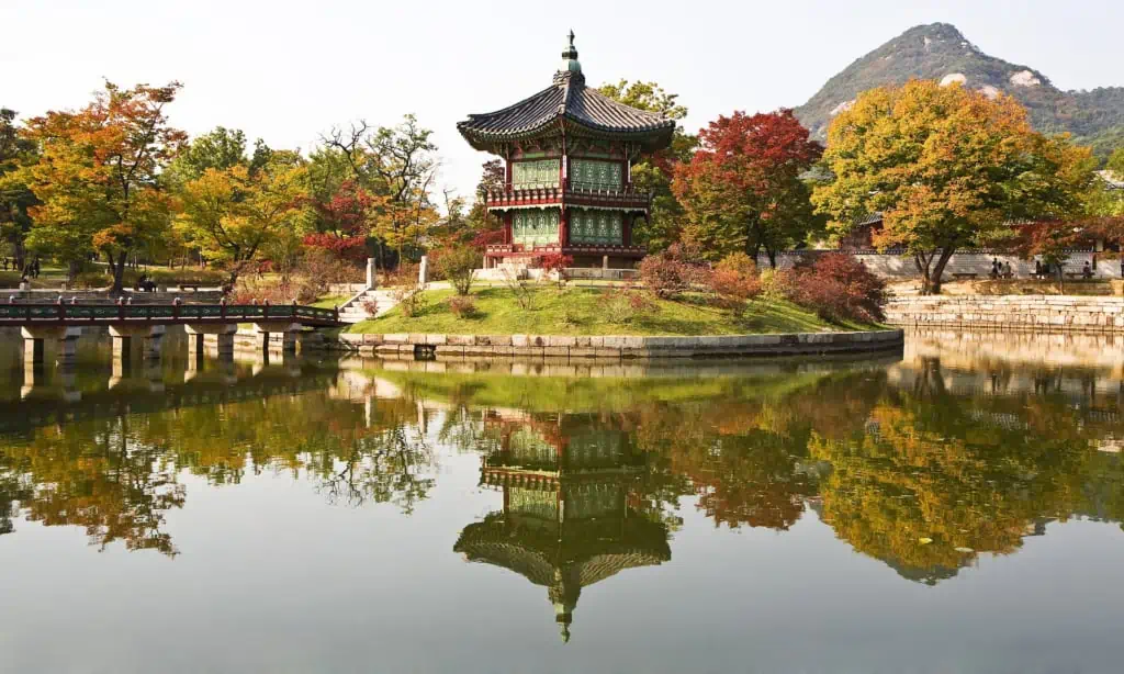 Gorgeous Hyangwonjeong Pavilion surrounded by a pond and beautiful red and yellow leaves during autumn in Korea