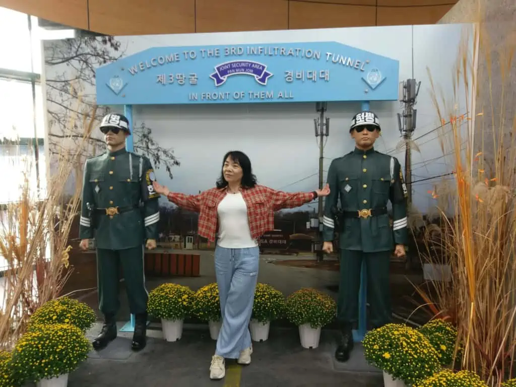 Someone is posing in front of a sign at the Third Tunnel of Aggression during our DMZ tour from Seoul.