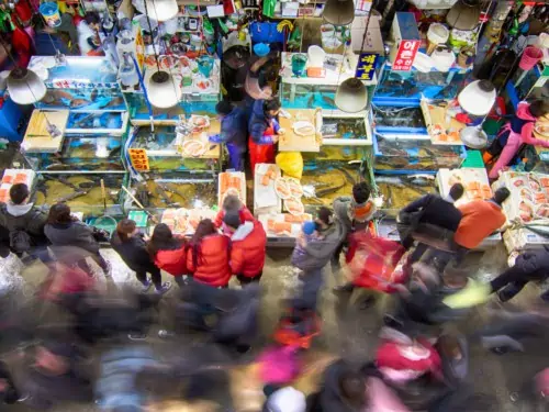 People purchasing seafood from a busy Noryangjin Fisheries Wholesale Market in Seoul