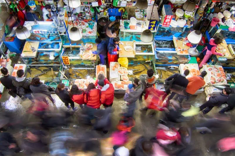 People purchasing seafood from a busy Noryangjin Fisheries Wholesale Market in Seoul