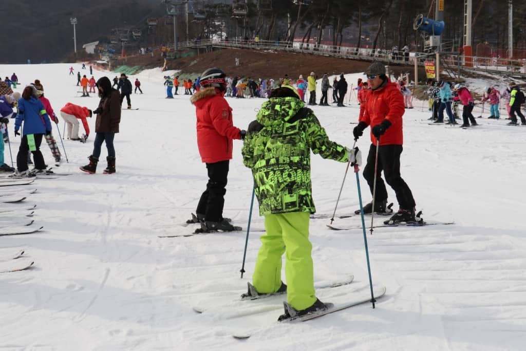 A couple taking lessons before skiing in Korea