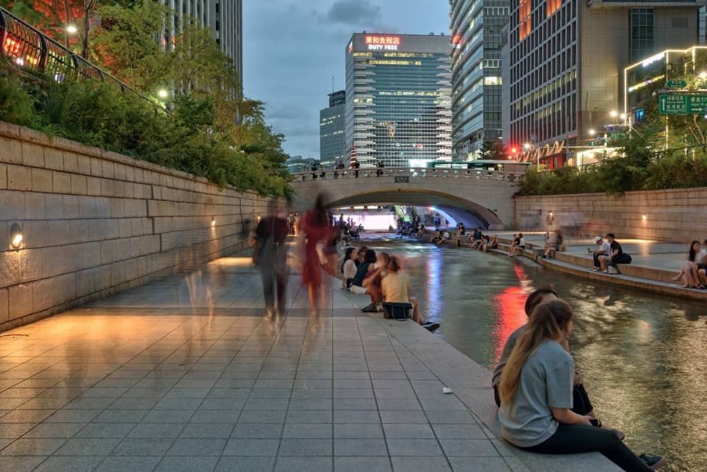 People hanging out at Cheonggyecheon Stream in downtown Seoul