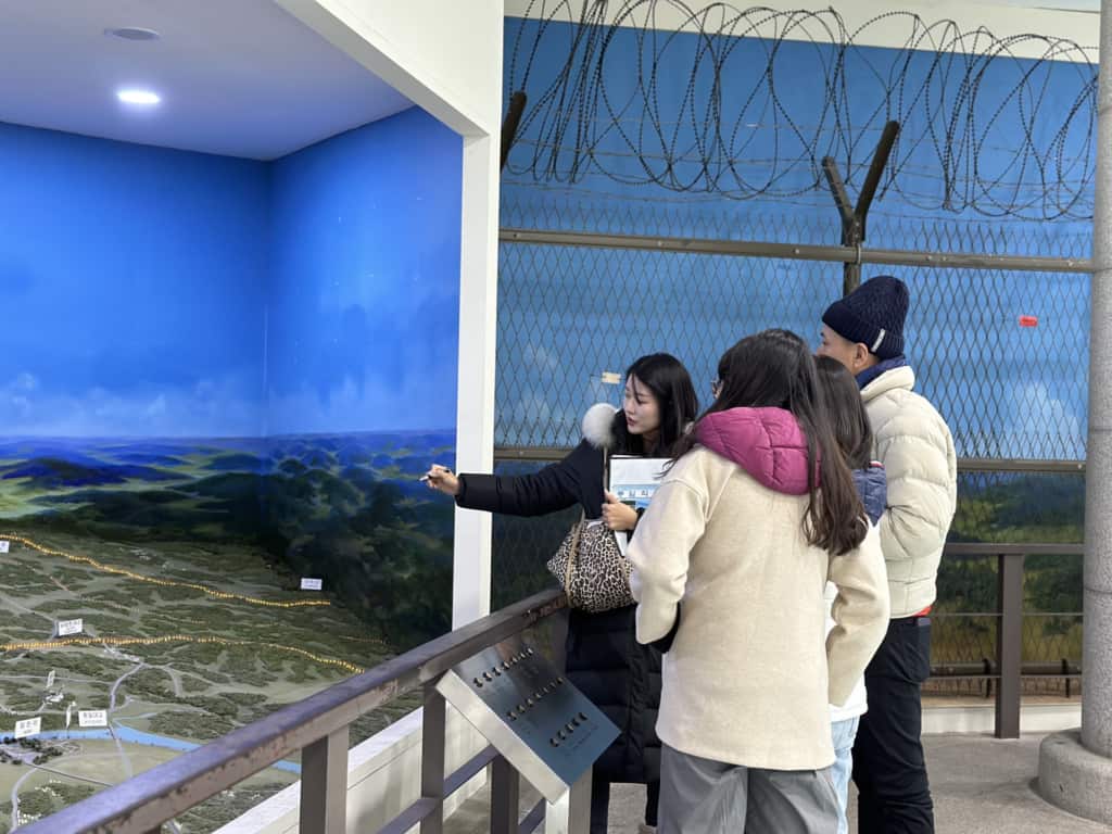 One of VIP's guides giving an explanation of a model map at the DMZ Exhibition Hall