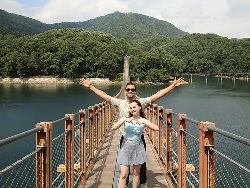 A couple posing for a photo on Majang Lake Suspension Bridge near the DMZ