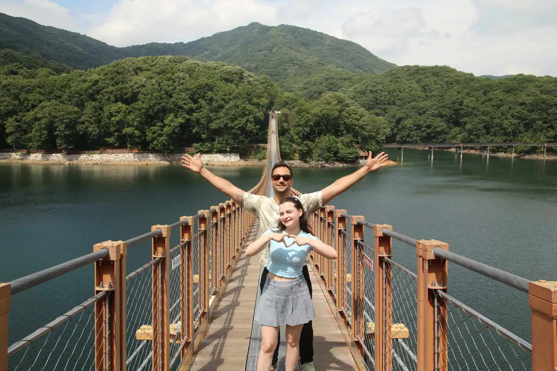 A couple posing for a photo on Majang Lake Suspension Bridge near the DMZ