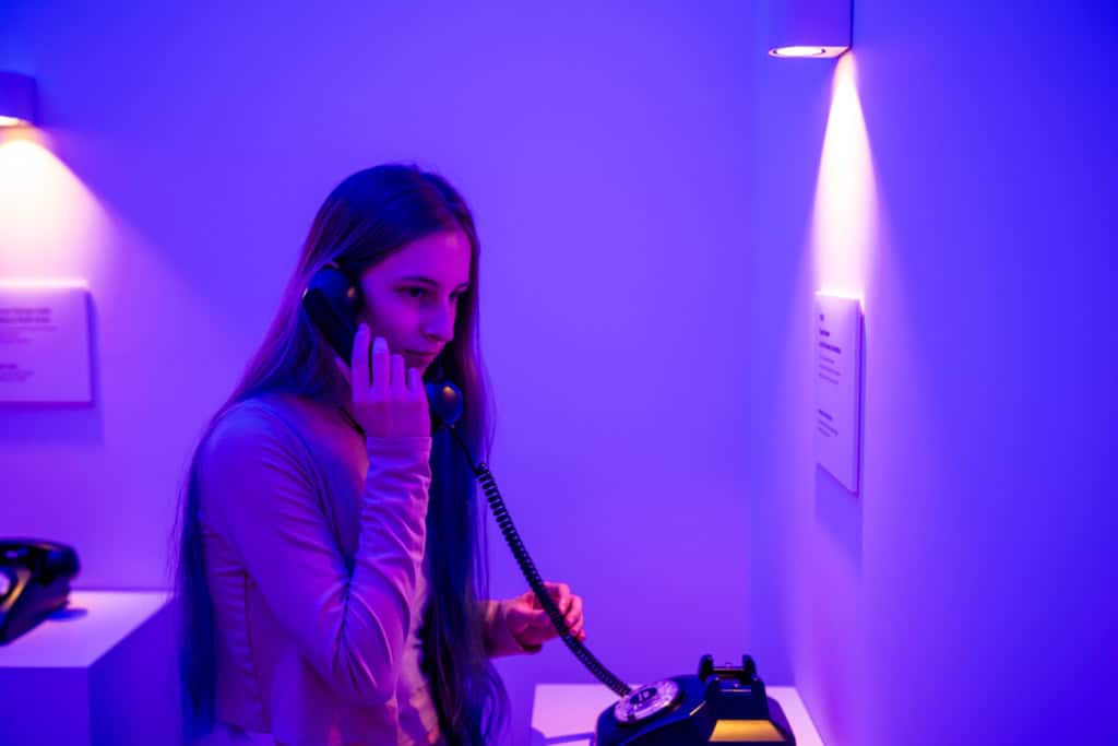 A girl listening to a recording made during the Korean war at the JSA Museum